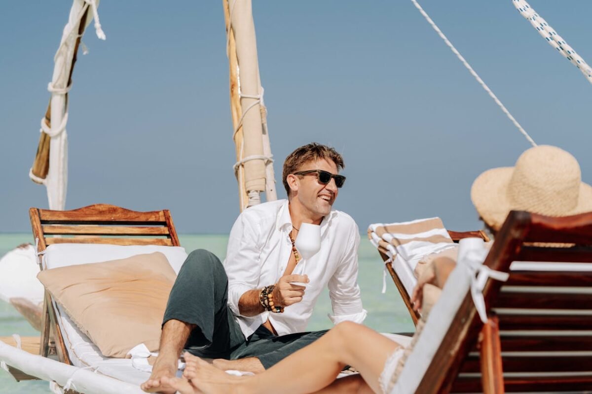 A couple enjoys a sunny day on a dhow boat, relaxing in Zanzibar, Tanzania.